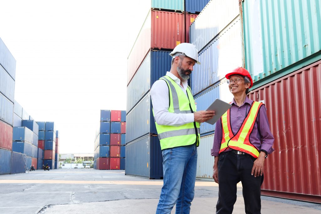 Two manufacturing employees looking at how to automate production scheduling